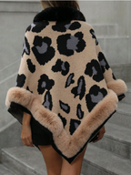 Leopard print coat with fur trim worn by a person on marble steps