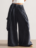 Dark gray wide-leg pants worn by a person on a light background