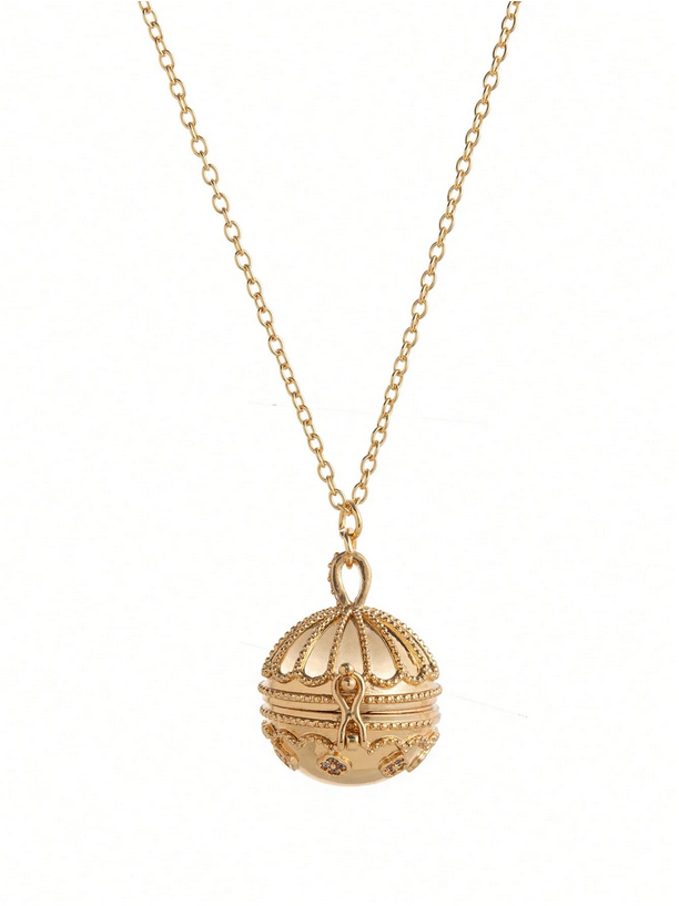 Gold necklace with a detailed pendant on a white background
