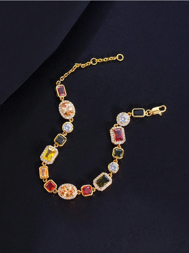 Gold bracelet with colorful gemstones on a dark background