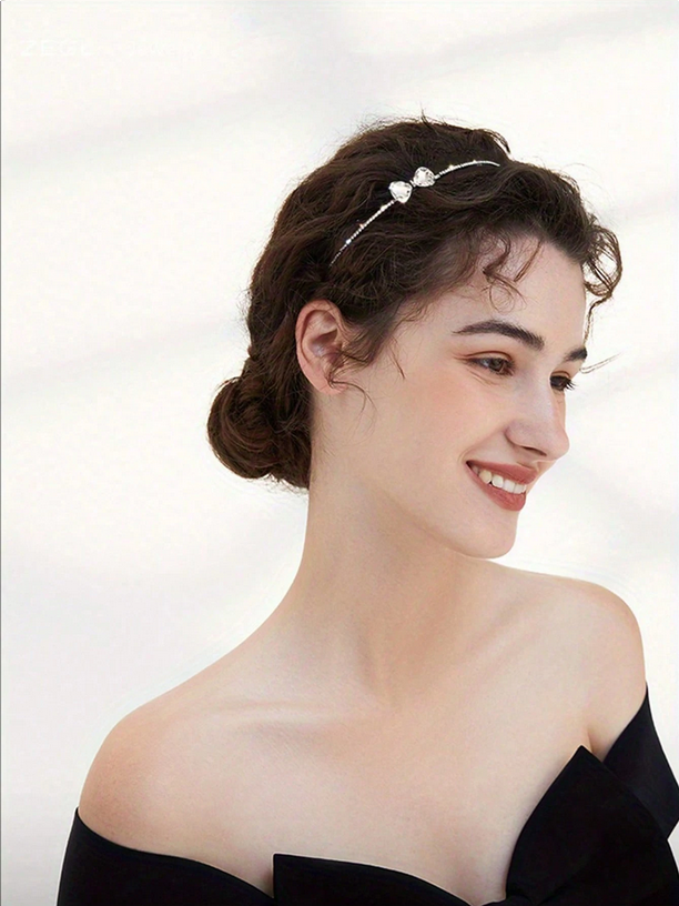 Woman wearing a decorative headband with a plain background