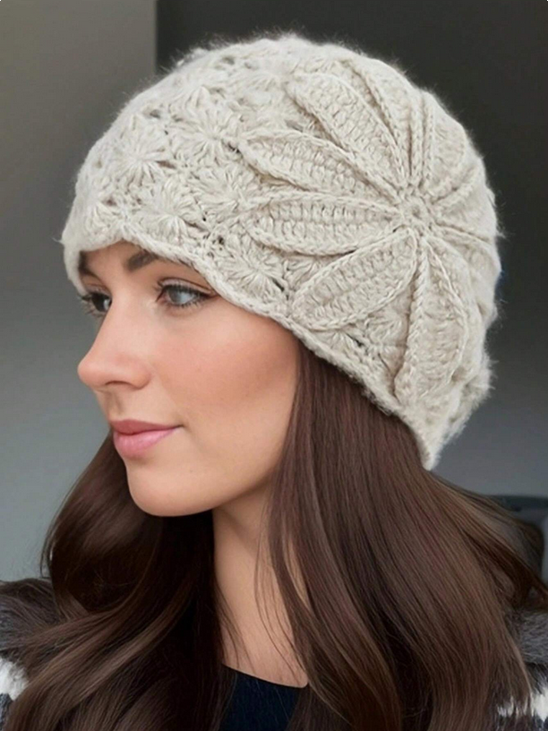 Woman wearing a beige knitted hat against a neutral background