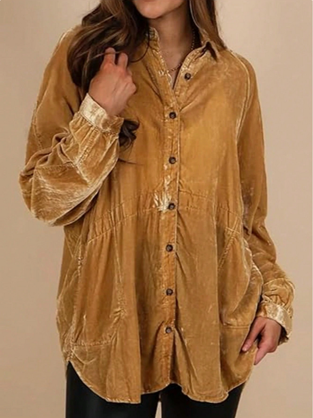 Person wearing a mustard yellow corduroy shirt against a beige background