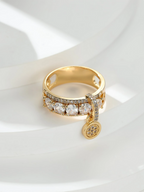 Gold ring with diamond accents on a white background
