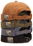 Stack of four denim caps in brown, green, gray, and black with visible brand labels.