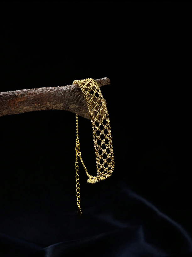 Gold bracelet on a dark background