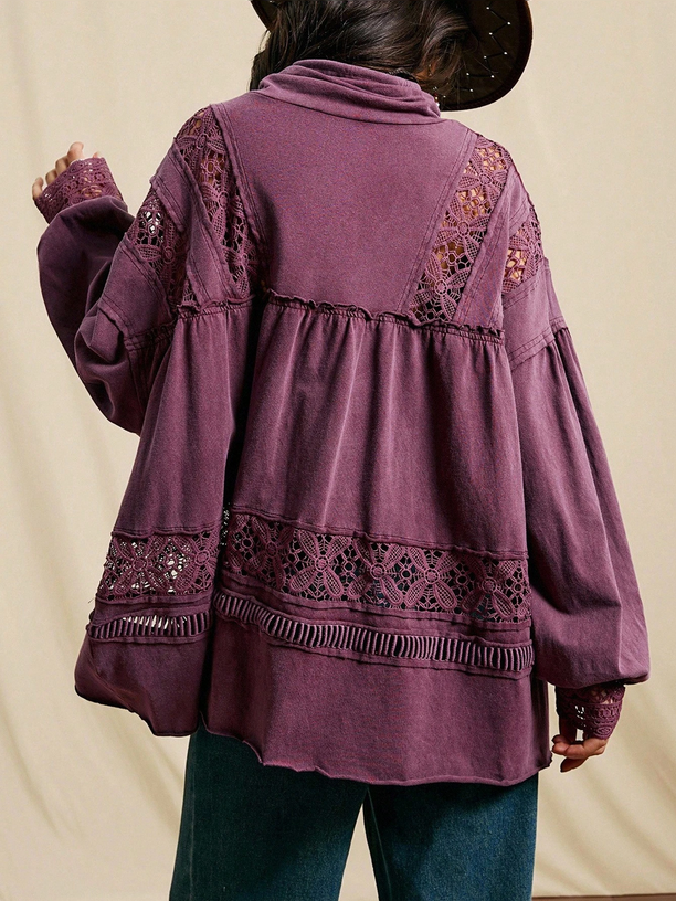 Purple blouse with lace details on a beige background