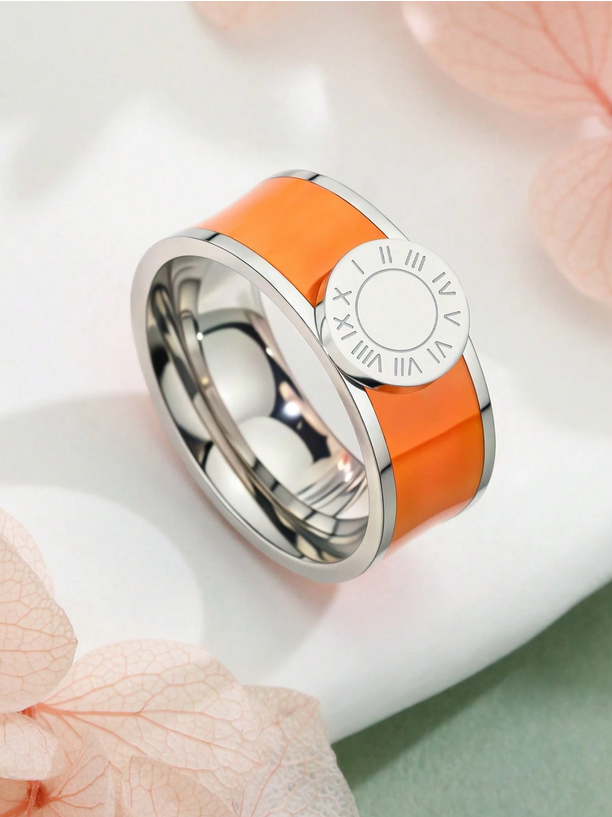Silver ring with orange band on a light background