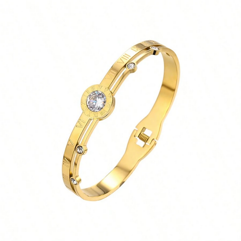 Gold bracelet with a diamond on a white background