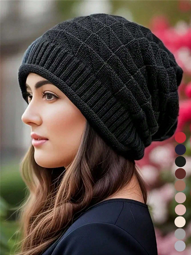 Woman wearing a black knit beanie with color swatches on a blurred background