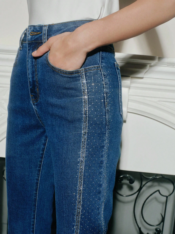 Person wearing blue jeans with a white background