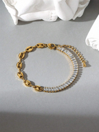 Gold bracelet with clear stones on a gray surface