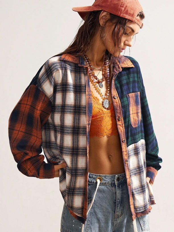 Person wearing a plaid shirt, jeans, and a red cap on a white background